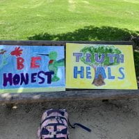 Be Honest" and "Truth Heals" read two posters. Beautiful posters from the REmove the Bells event and TeachTruth event, 2021
